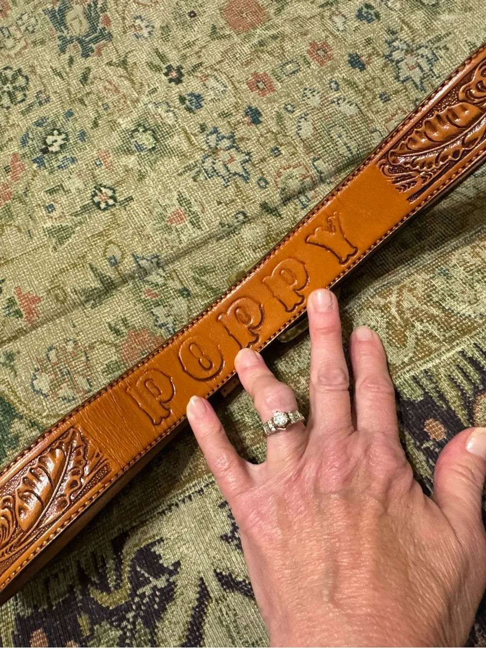 Circle Y hand tooled belt - 34. “Poppy” on back.